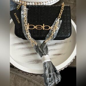 BEBE Black Crossbody with gold chain.